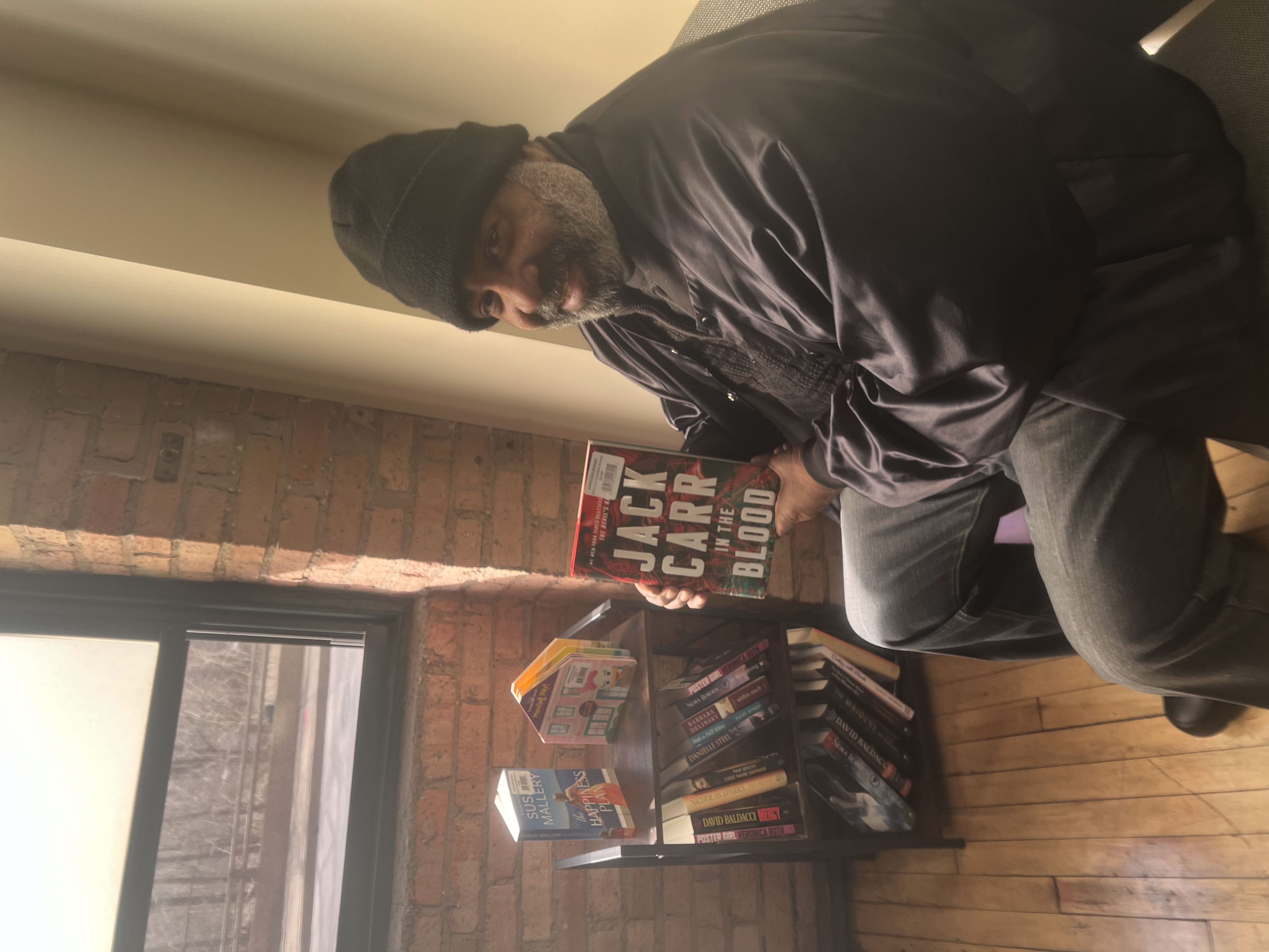 Client enjoying a book from the Literacy Hub