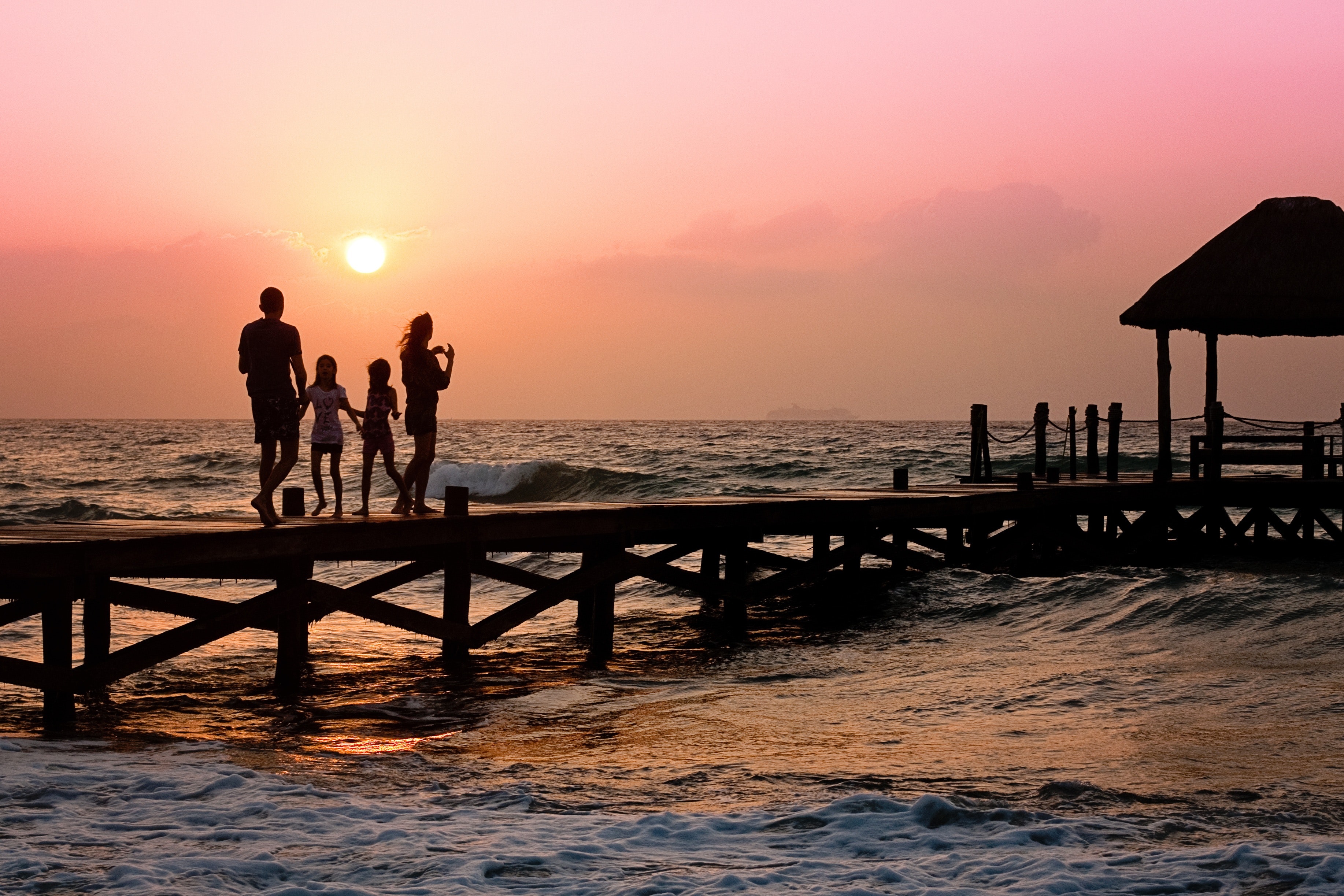 Family silhouette at sunset beach