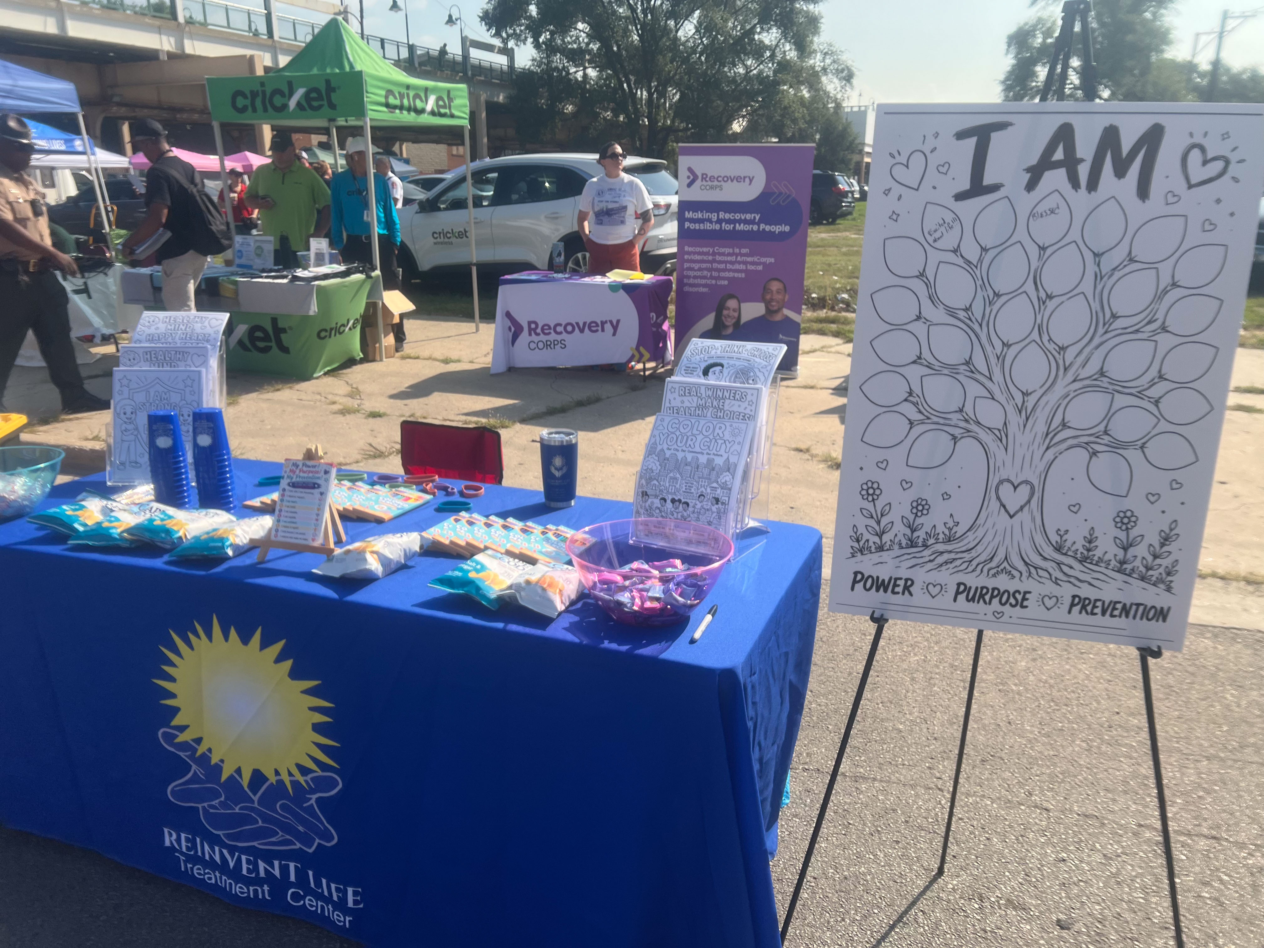 Community members visiting outreach tables at the fair
