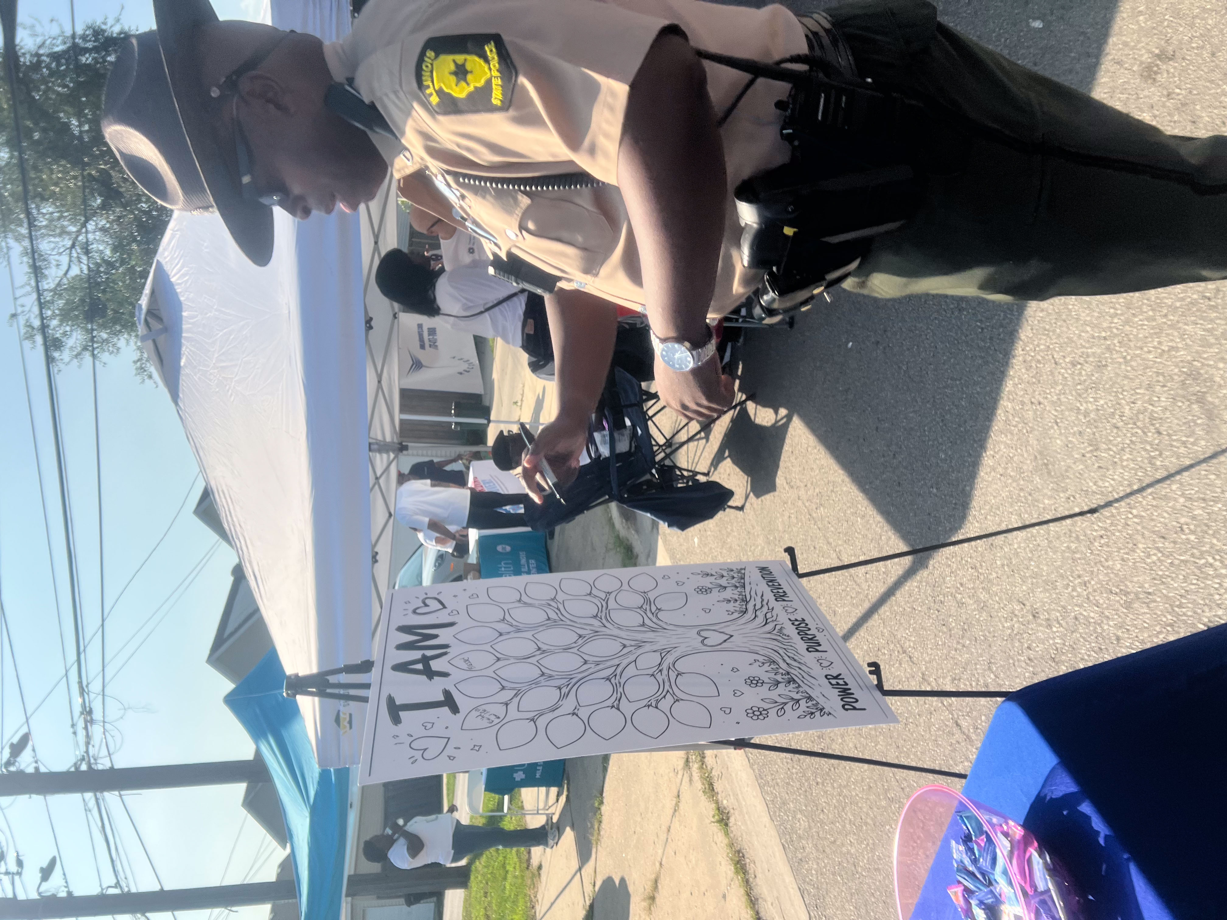 Illinois State Police officer visiting the Reinvent Life table